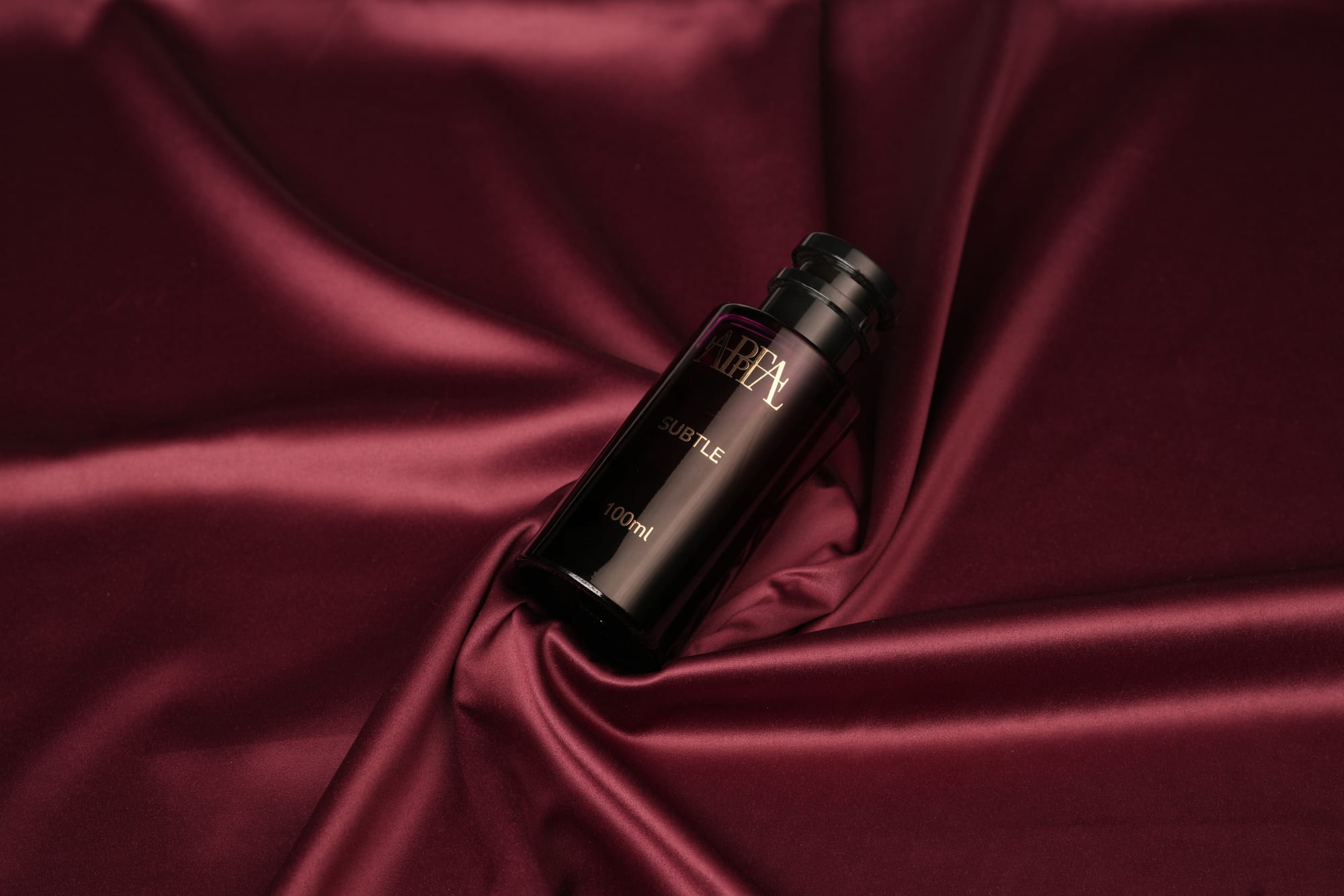 Subtle Eau de Parfum on burgundy